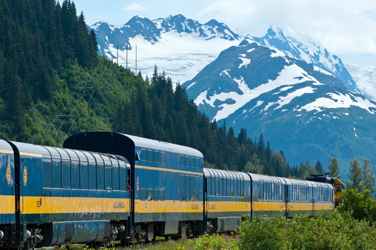 Seafood tartare with sesame breadstick and sauce dots on cucumber slice.