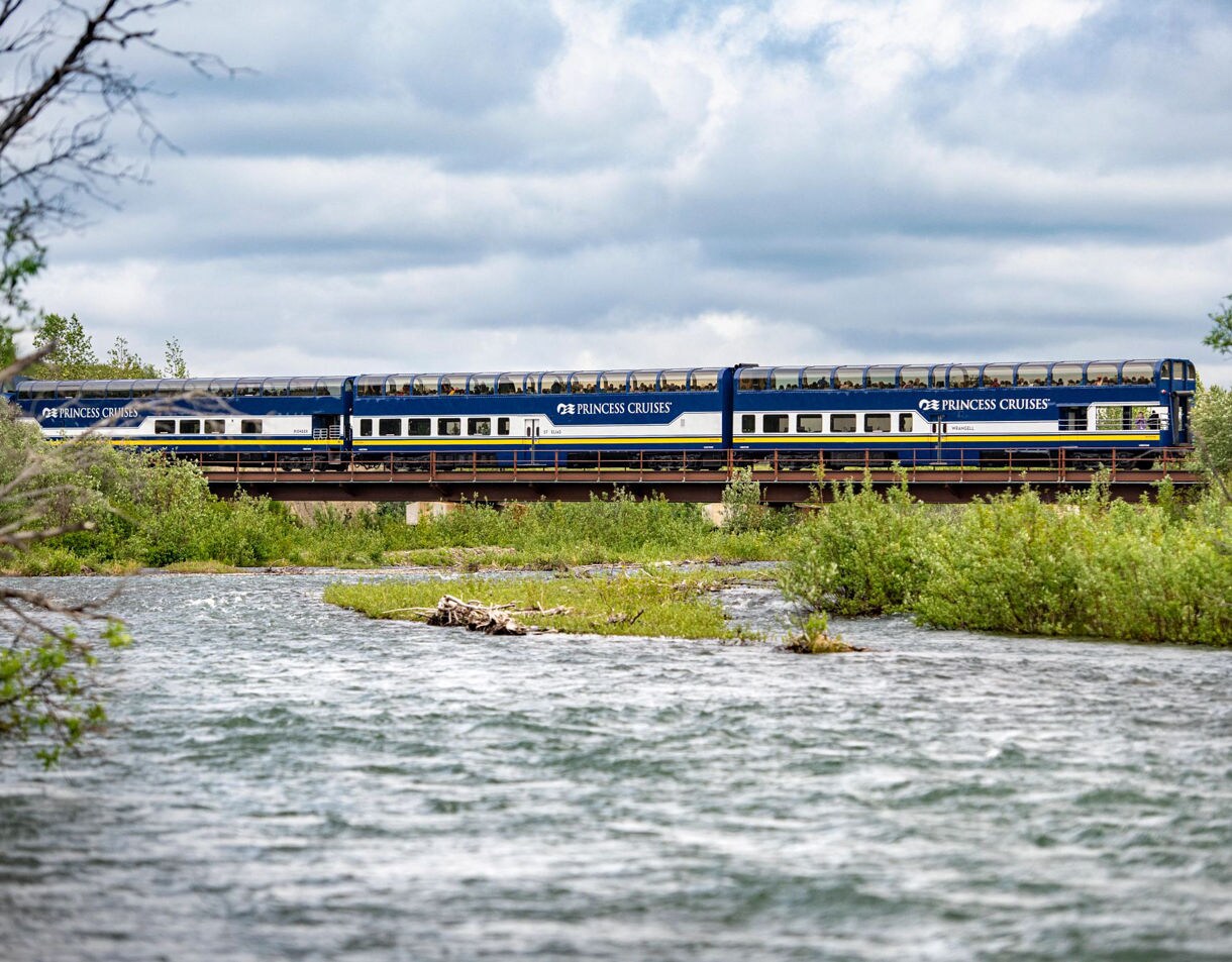 Seafood tartare with sesame breadstick and sauce dots on cucumber slice.