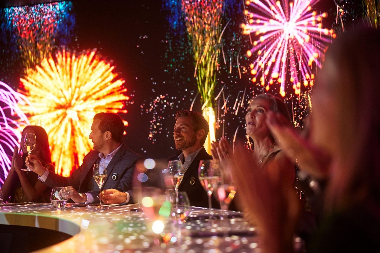 Colorful fireworks display lighting up the night sky, creating a celebratory atmosphere.