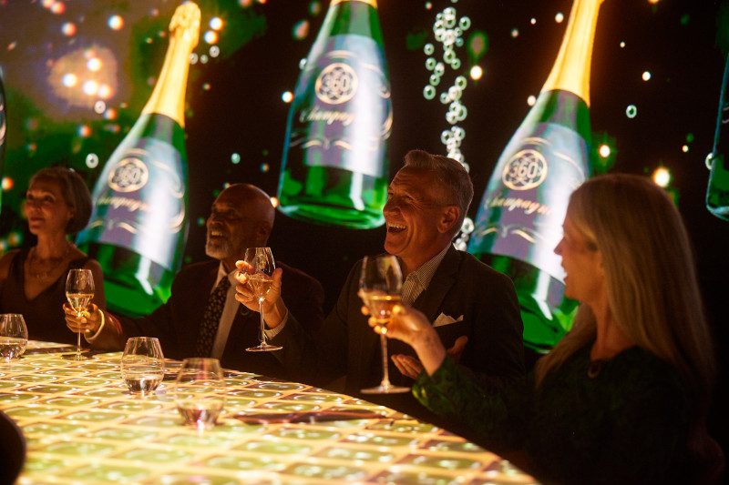 Illuminated bottles creating a magical atmosphere as guests dine in the evening. 