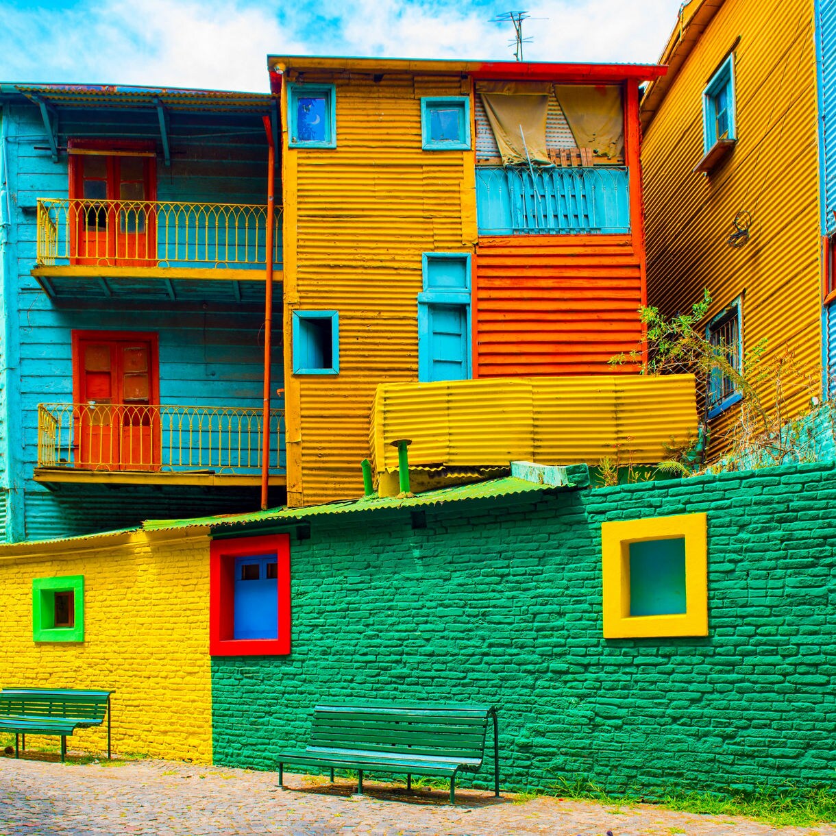 Brightly painted houses in La Boca with vivid blue, yellow, green, and orange walls.