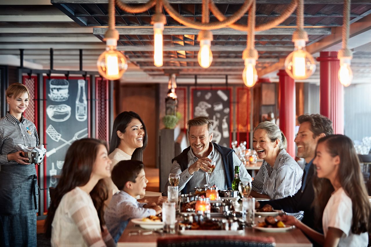 Group of people enjoying a meal at the Planks BBQ restaurant