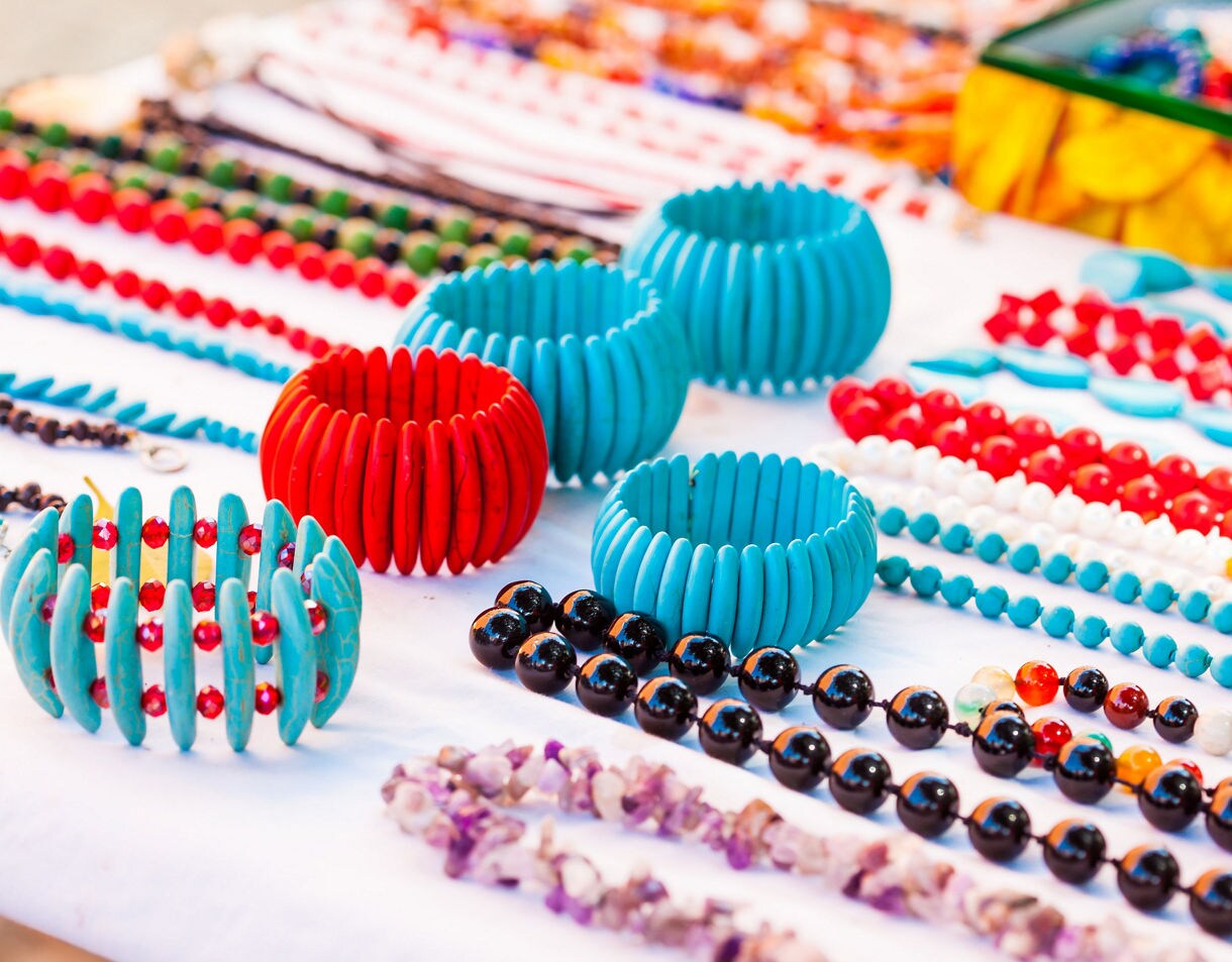 Display of bright beaded bracelets and necklaces at a street market stall in Cartagena, Colombia.