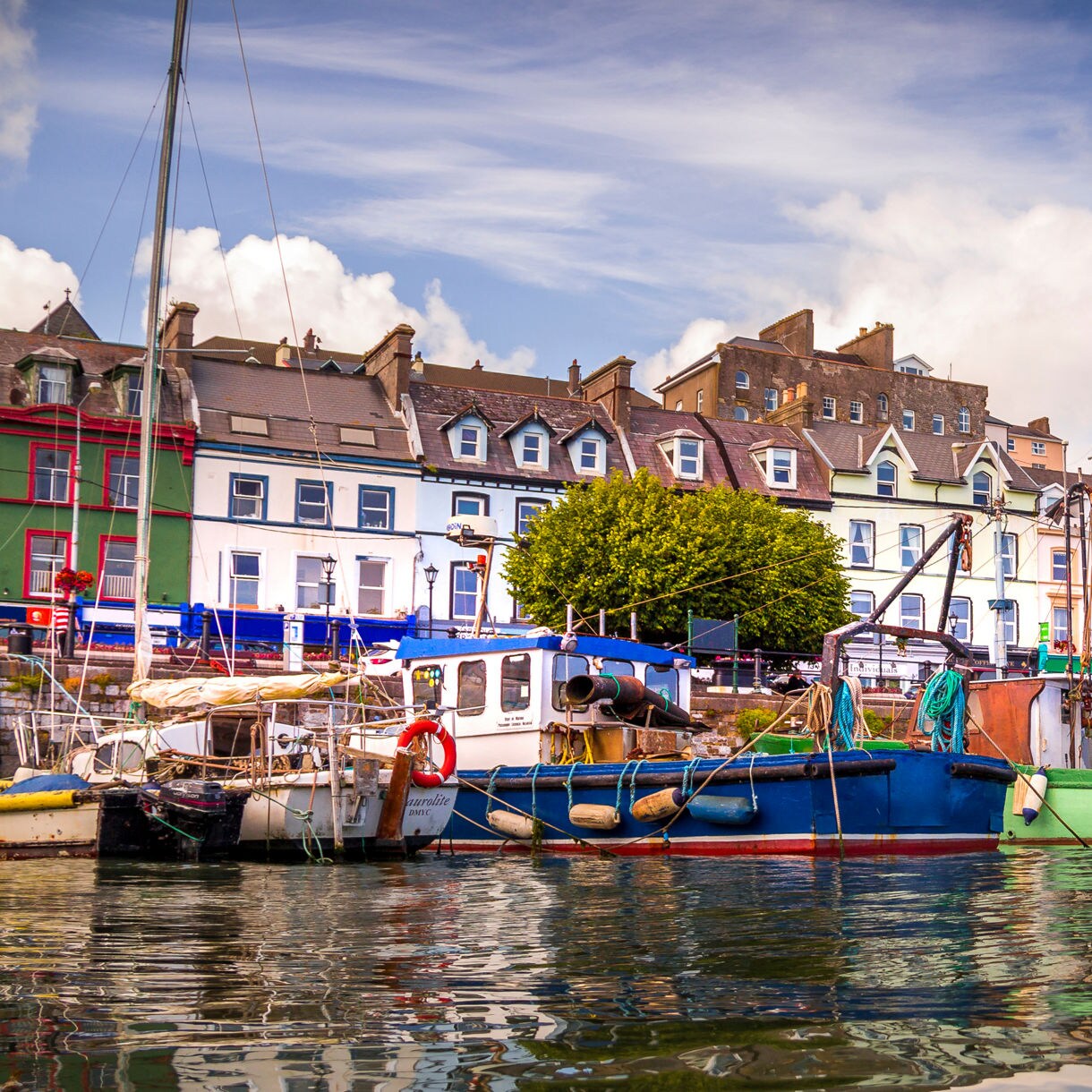 Colorful Fishing Boats Docked Along Vibrant Waterfront