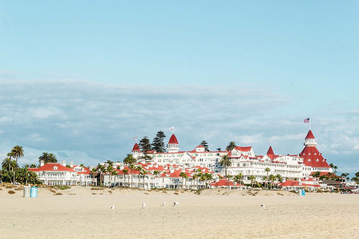 The historic Hotel del Coronado on Coronado Beach, featuring its iconic red rooftops and white Victorian architecture.