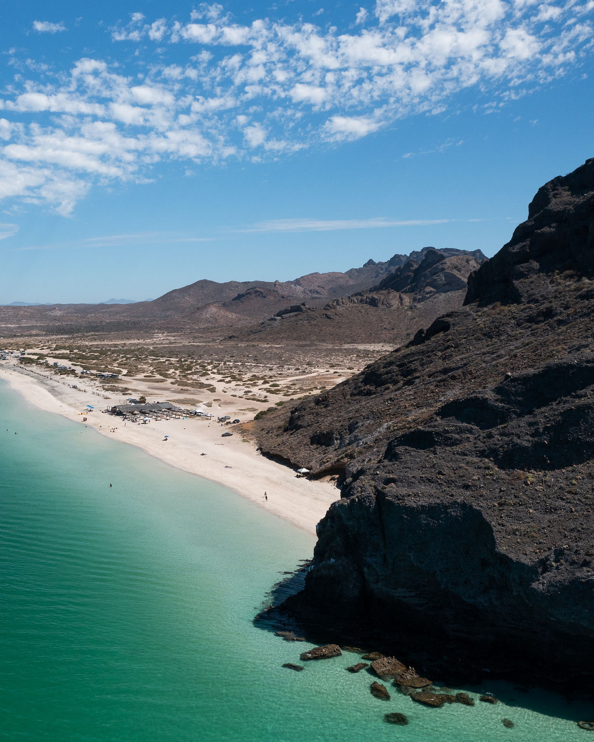 Aerial view of turquoise water embracing white sand beach in Baja California Sur, Mexico