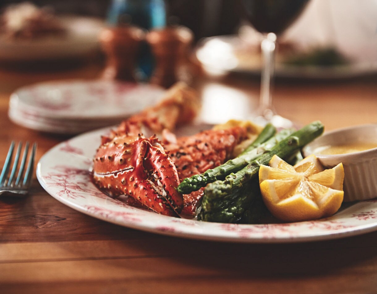 Alaska king crab served with asparagus, fresh lemon, and warm drawn butter.