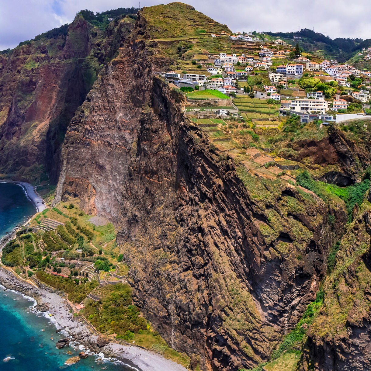 Dramatic view of Cabo Girão sea cliffs in Madeira, with villages and terraced farmland perched high above the Atlantic Ocean.