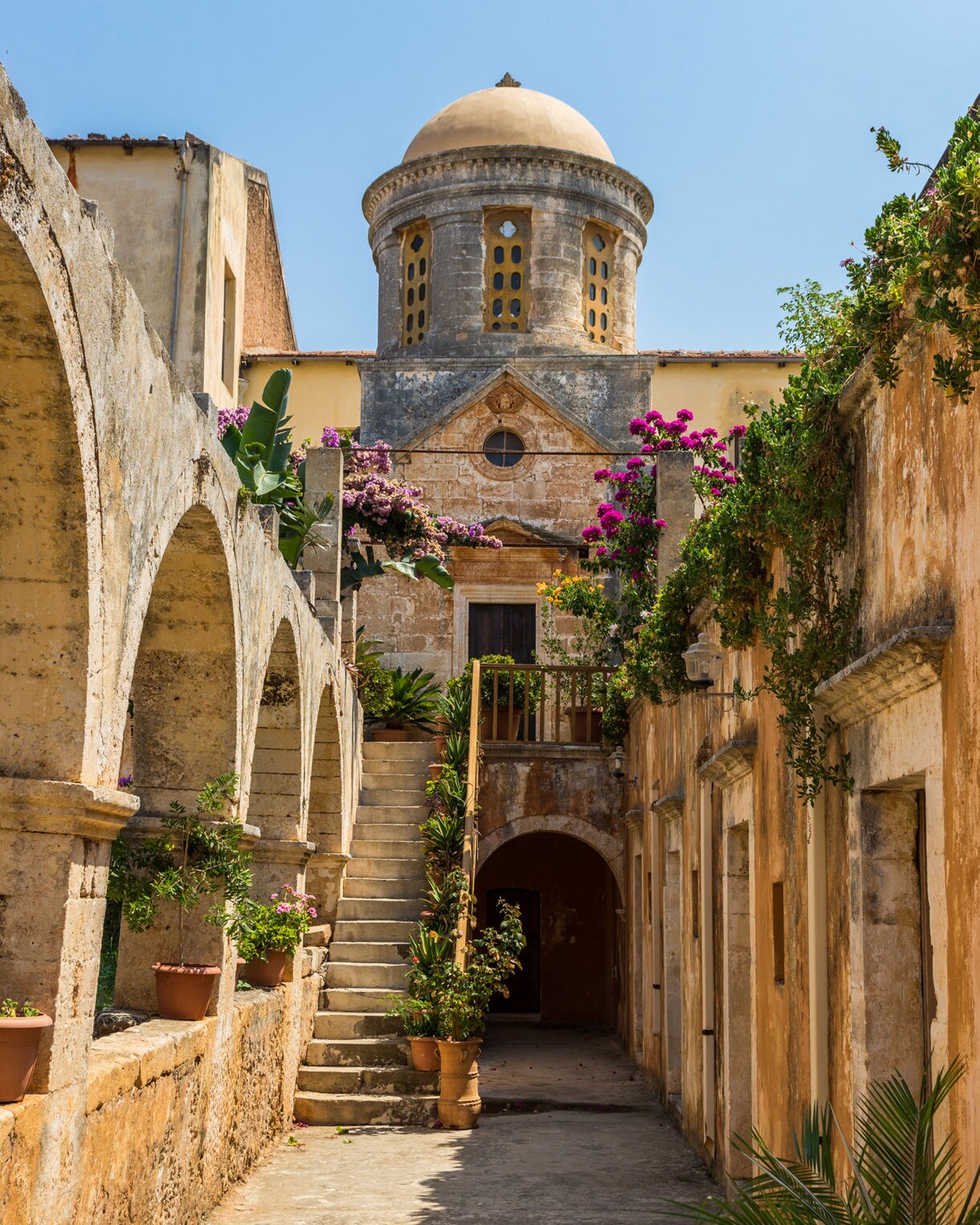 Courtyard of the Monastery of Agia Triada Tzagaroli in Crete, featuring arched