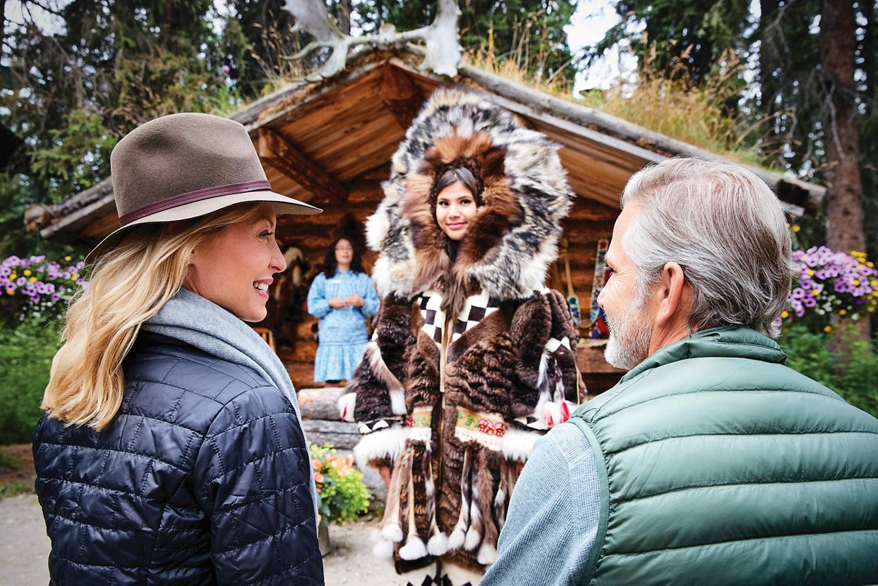 Learn about traditional Athabascan garments from Alaskan Native guides during a stop at Chena Village on the Riverboat Discovery cruise.