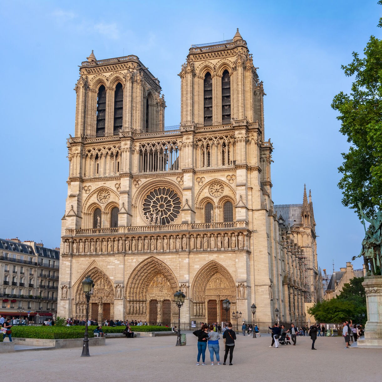 The front façade of Notre-Dame Cathedral with twin towers, rose window and Gothic arches.