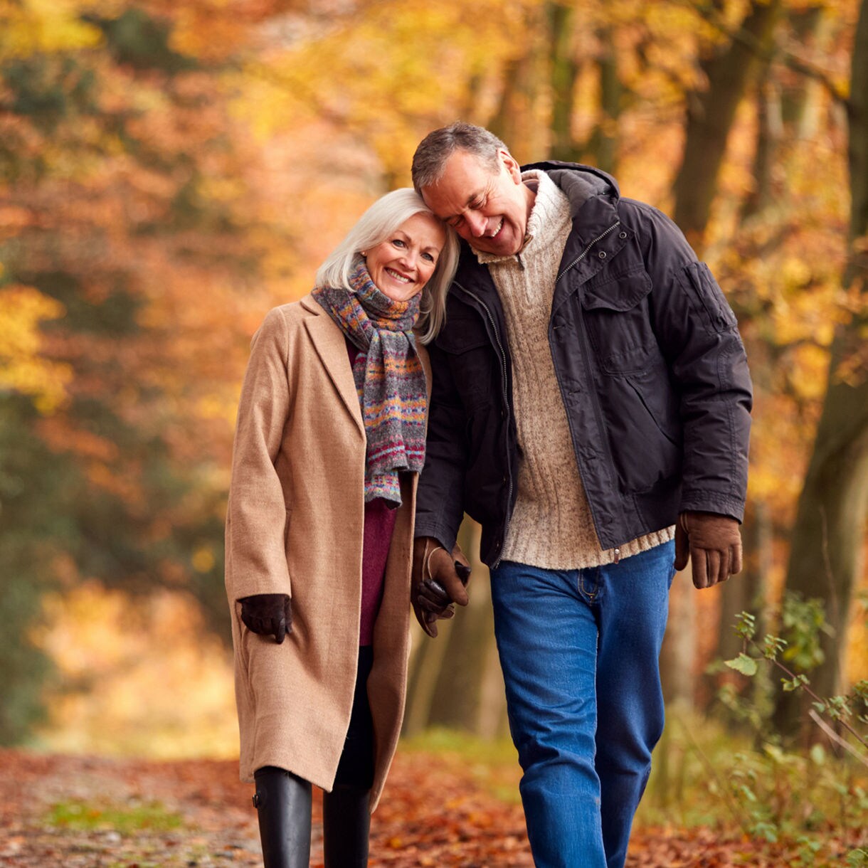 Couple walking on a Cape Elizabeth trail in autumn.