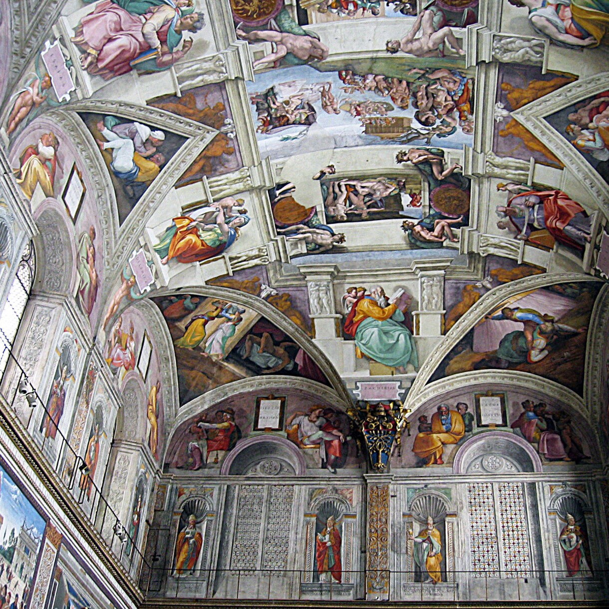 The ornate ceiling of the Sistine Chapel in Vatican City, covered with Michelangelo’s vivid frescoes depicting biblical scenes and figures.