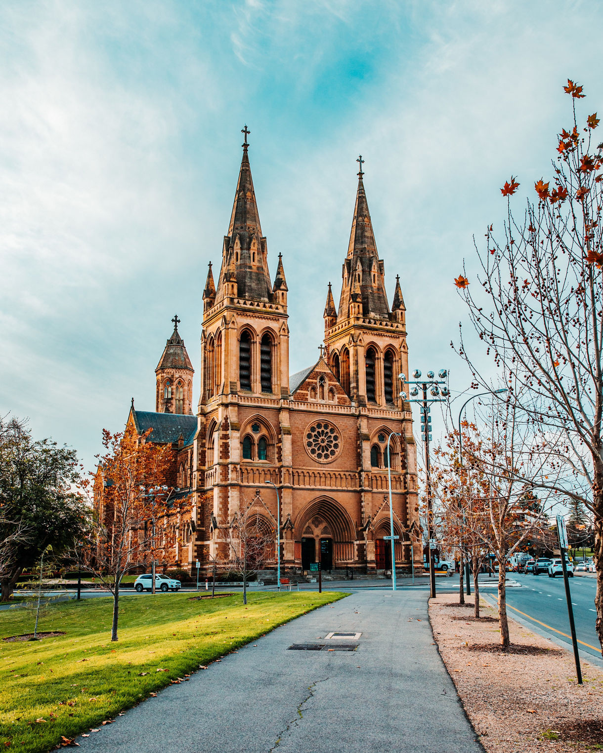 Front view of St. Francis Xavier’s Cathedral in Adelaide, featuring twin Gothic spires, arched entrances and intricate stone detailing.