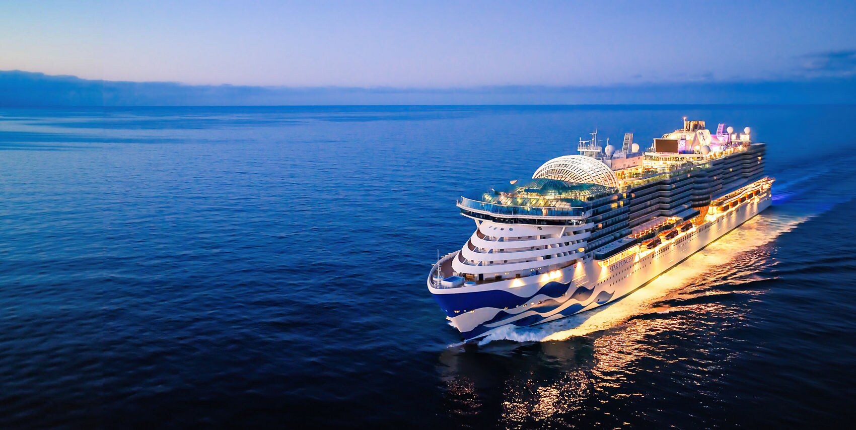 A Princess Cruises ship sails at dusk, representing the travel experience recipients can enjoy when redeemed with a Classic Gift Card.