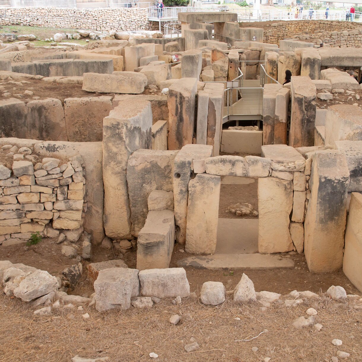 Stone doorways and massive blocks forming the Tarxien Temples, a prehistoric archaeological site in Malta.