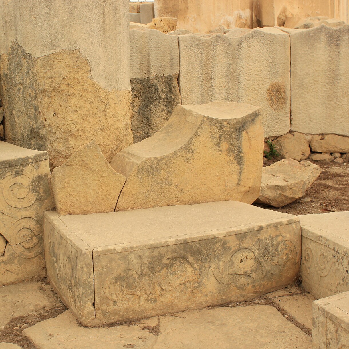 Close-up of decorated stone blocks with spiral patterns at the Tarxien Temples in Malta.