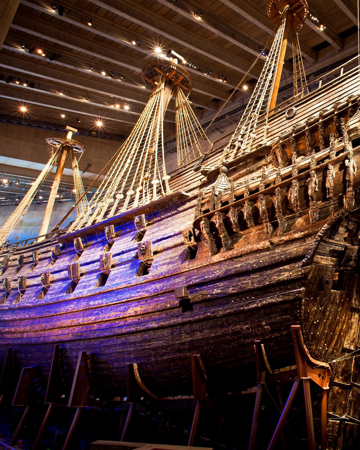 The 17th-century Vasa warship on display inside the Vasa Museum in Stockholm, showcasing intricate wooden carvings, masts and rigging under museum lighting.