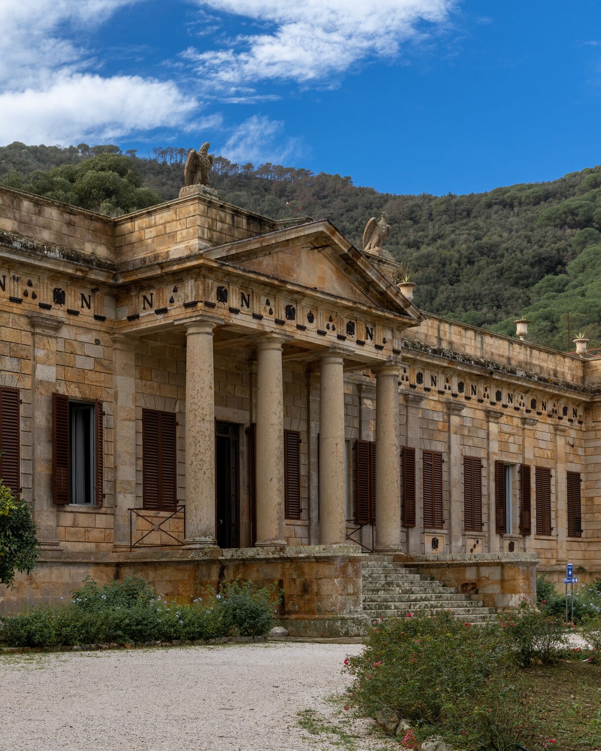 Modern rust-colored European Solidarity Centre building in Gdańsk, Poland, with industrial-style design and engraved concrete wall in the foreground.