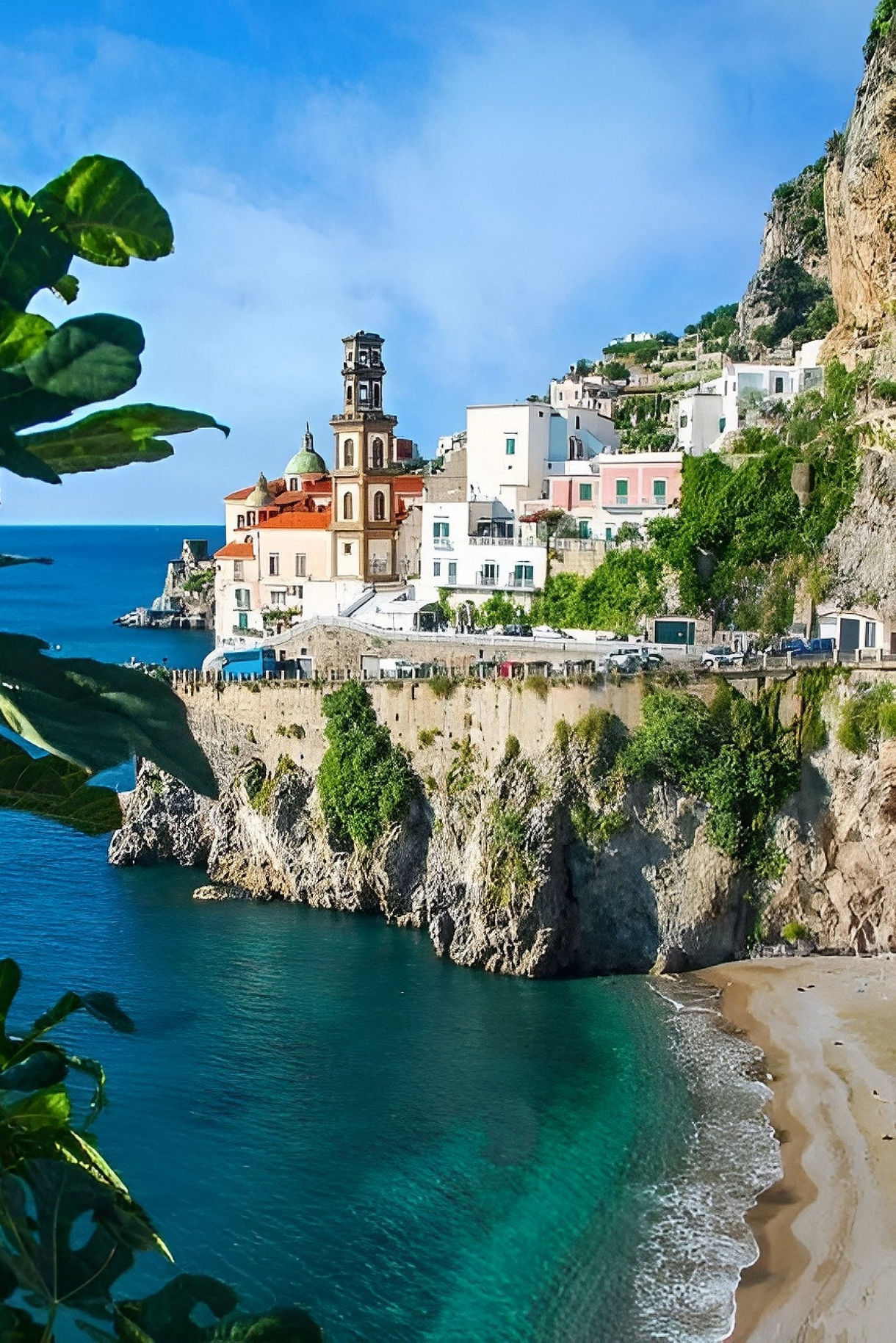 A coastal village on the Amalfi Coast with pastel buildings perched on rocky cliffs above a small sandy beach and vivid blue water, framed by green leaves.