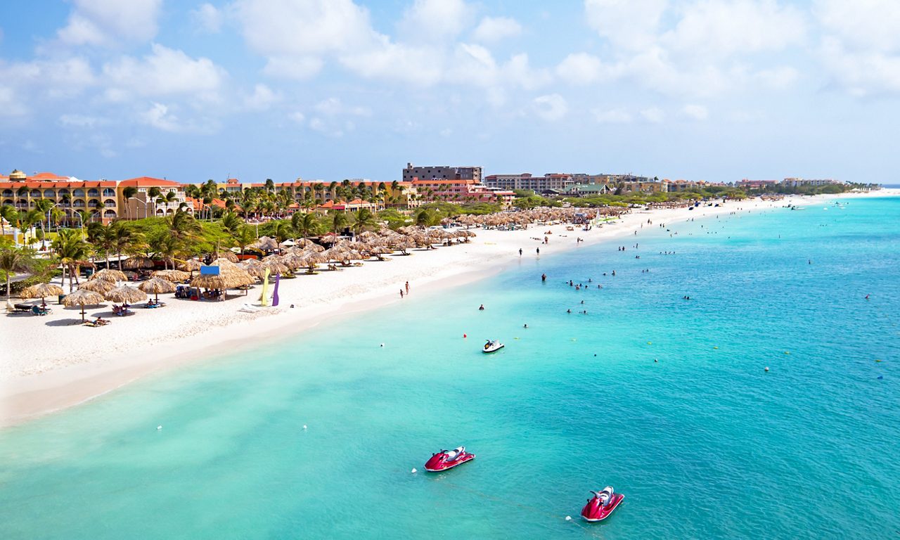 People swimming in the waters of Eagle Beach, Aruba.