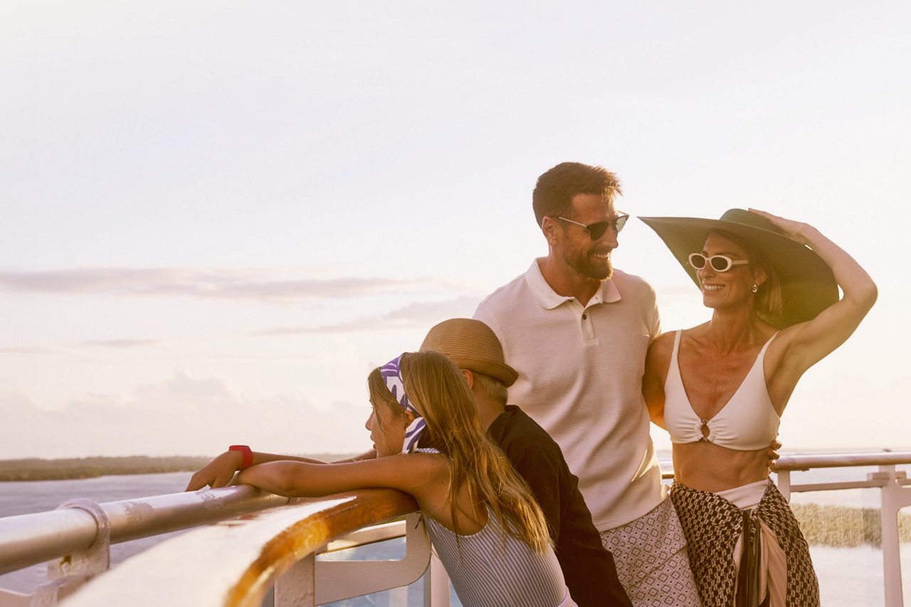 Couple at ship balcony in Alaska.