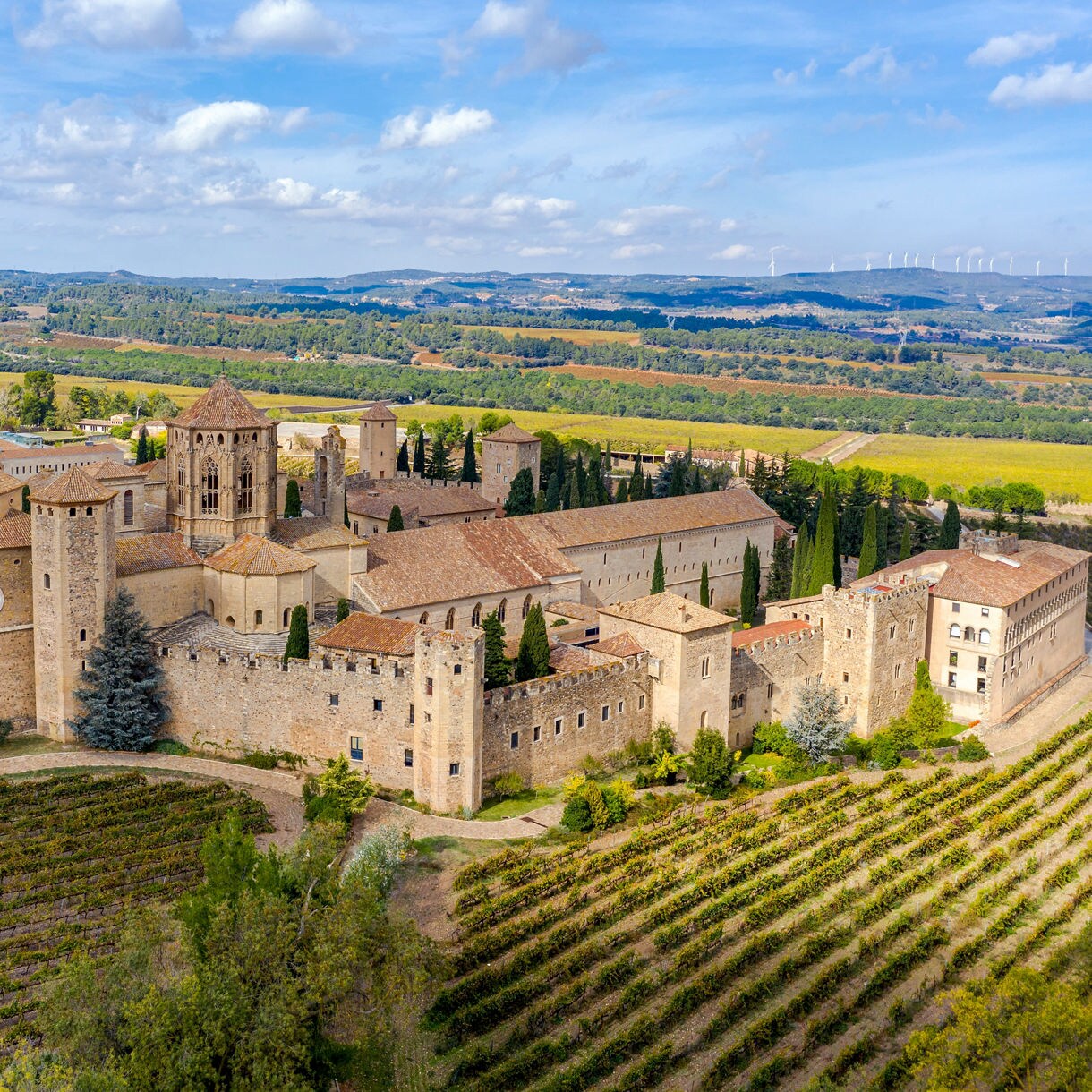 Aerial view of the Santa María de Poblet Monastery in Catalonia, Spain, showcasing Romanesque and Gothic architecture.