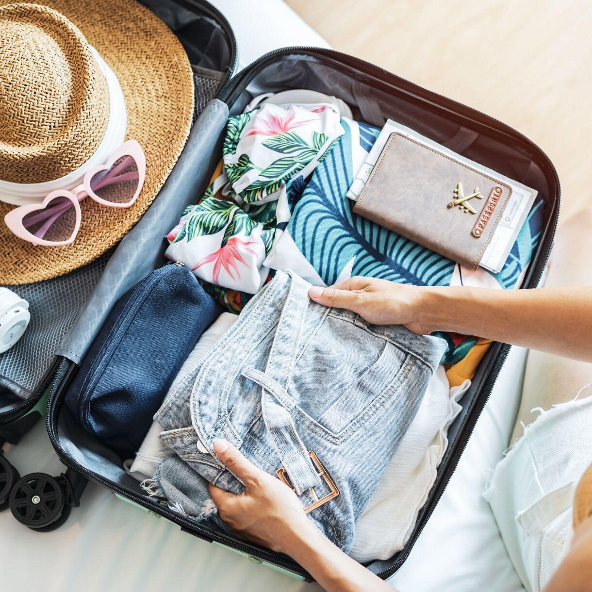 Woman packing suitcase for vacation.