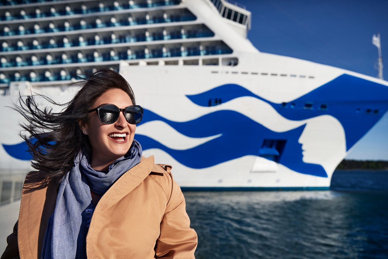 Woman posing at the deck. Princess ship at the background.