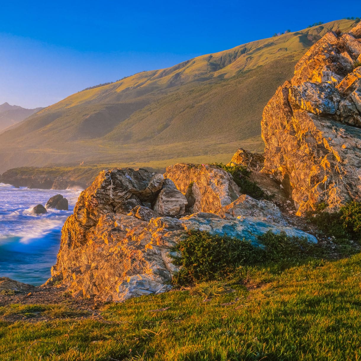 Seascape of coastline with breaking waves in a rocky cove, Big Sur, California.