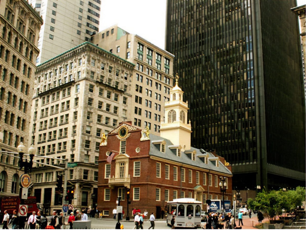 Picture Boston's historic Old State House, a stunning 18th-century building with a golden dome, surrounded by modern skyscrapers. The contrast between old and new architecture showcases the city's rich history and urban development.