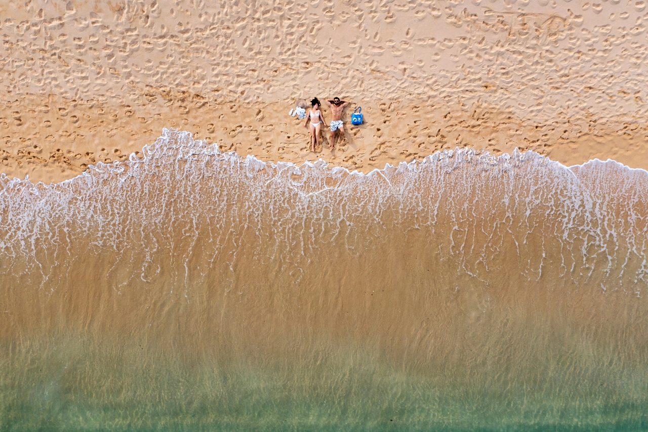 Aerial view of a couple laying on the beach, Cabo San Lucas, Mexico