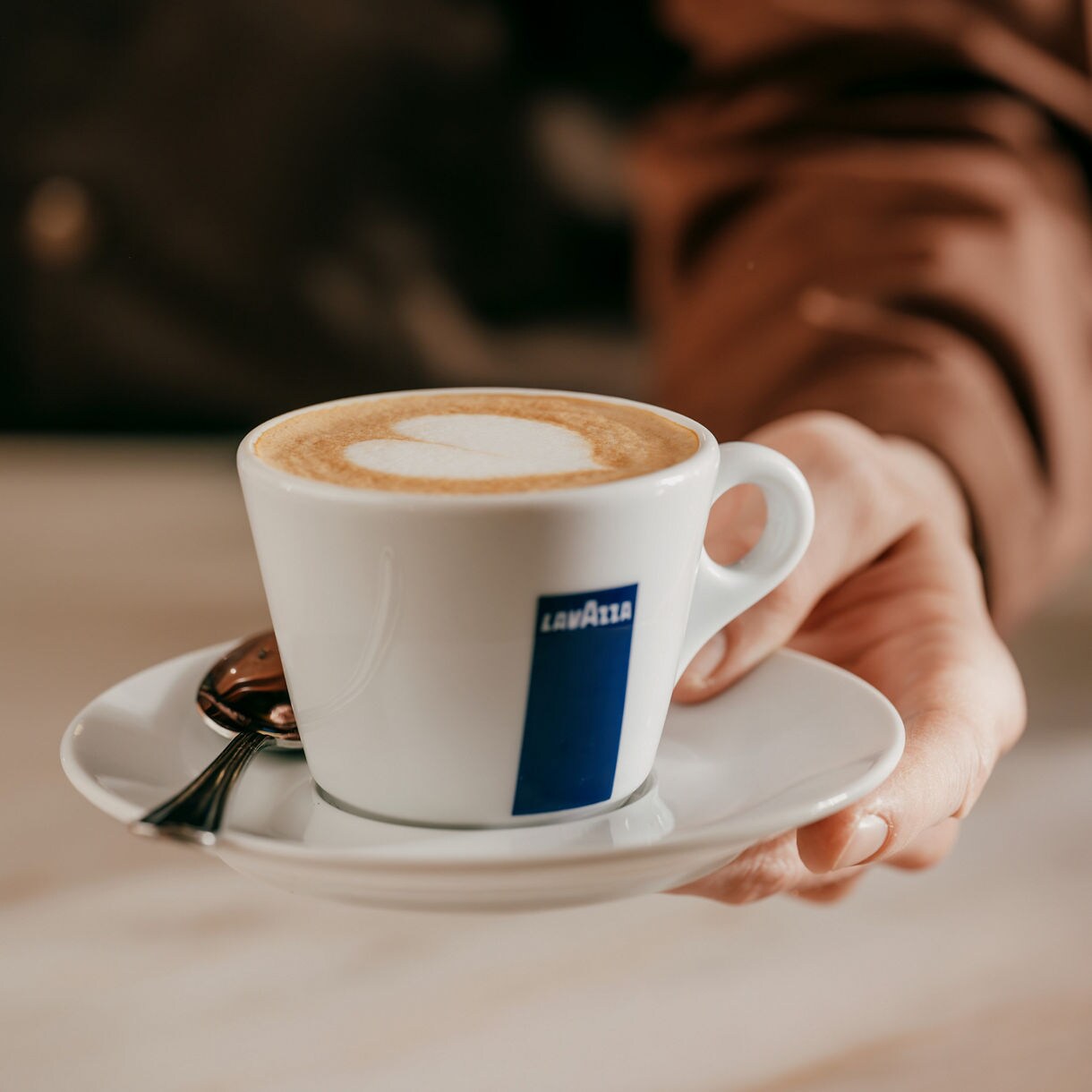 international cafe hand holding cup of coffee