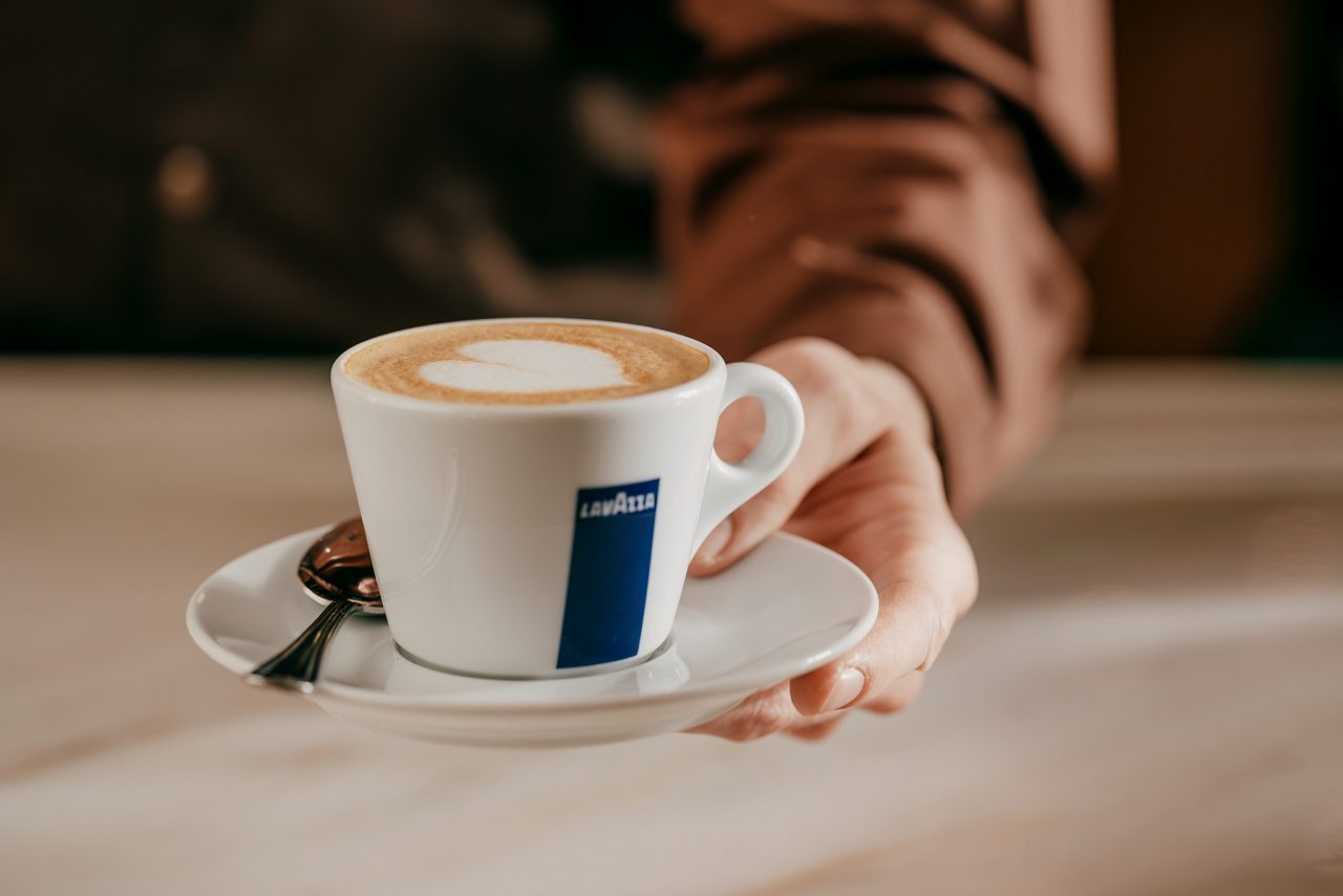 hand holding a cup of coffee