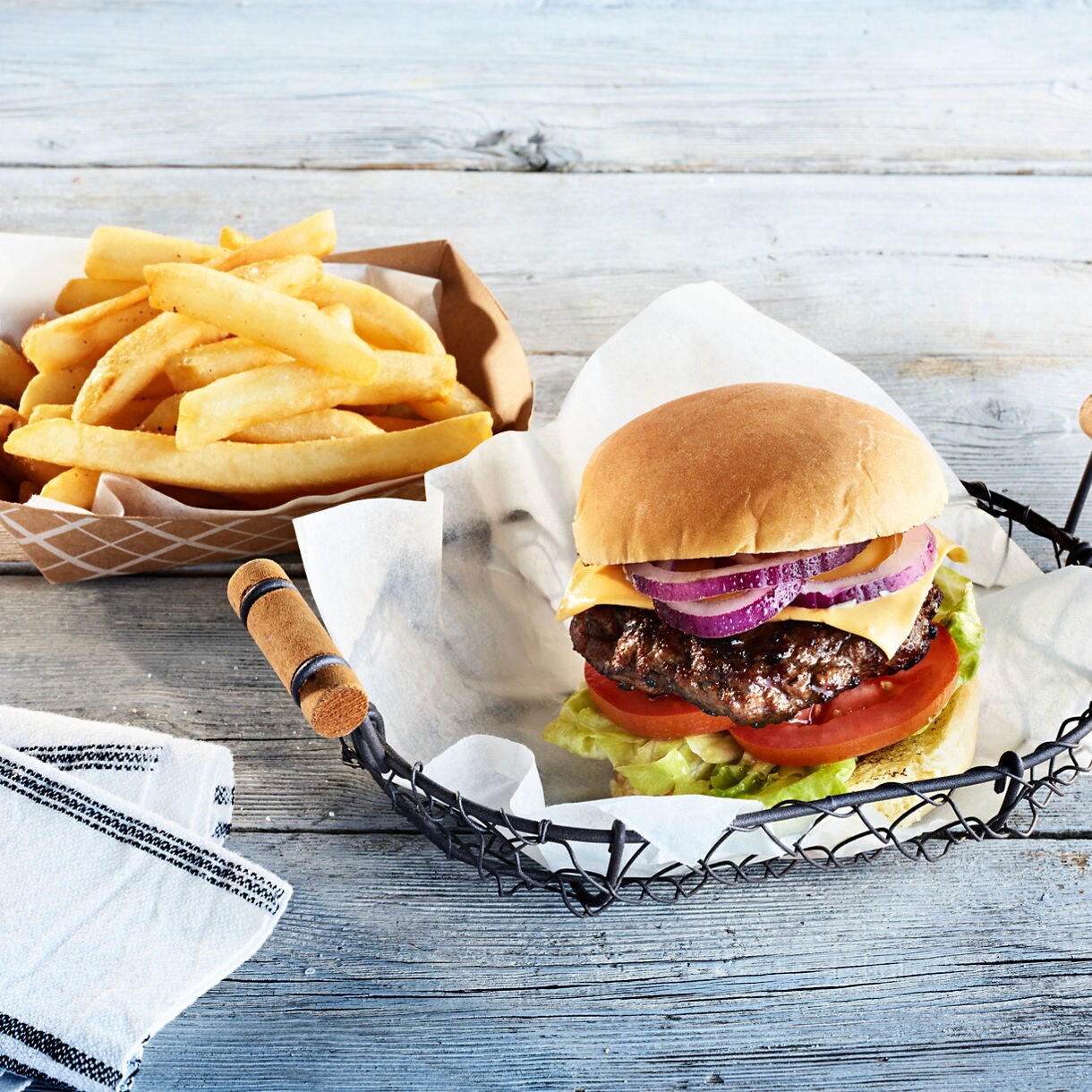 Cheeseburger with fries close up.