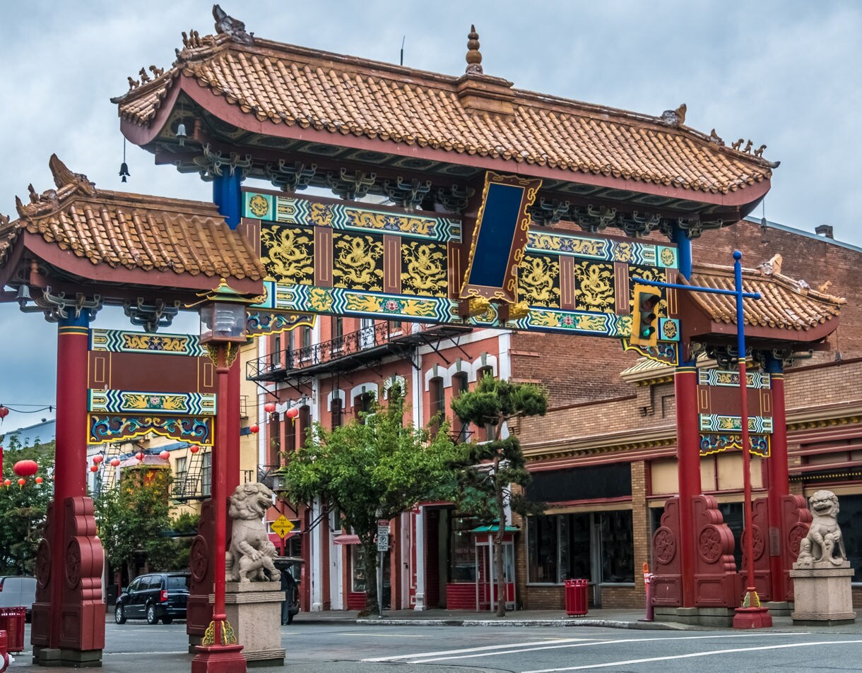 Traditional Chinese archway with intricate red, gold and blue detailing marking the entrance to Victoria’s Chinatown.