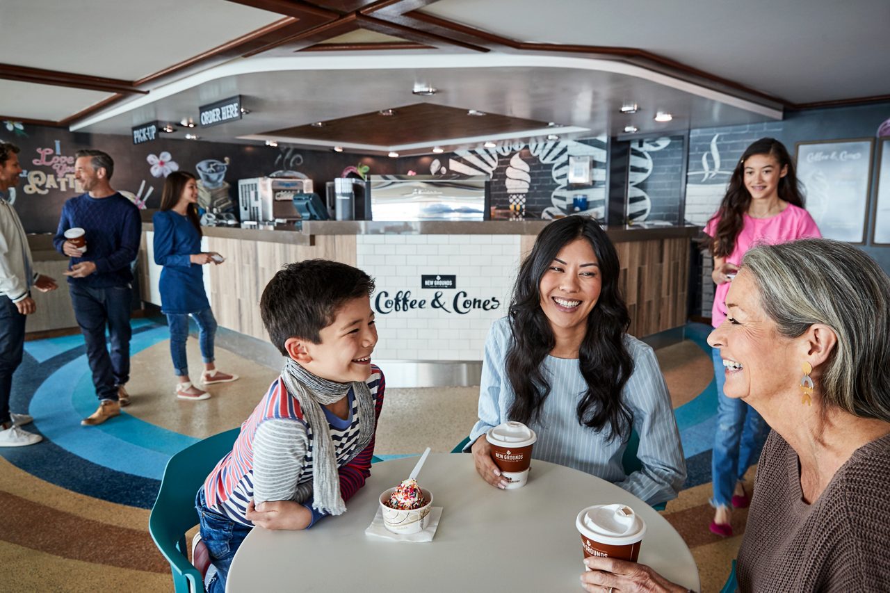 A family enjoying ice cream and coffee at the Coffee & Cones station on the ship's deck.