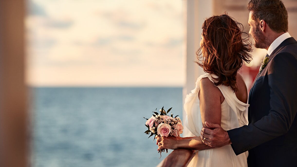Coral Princess couple bride groom flowers rail sunset