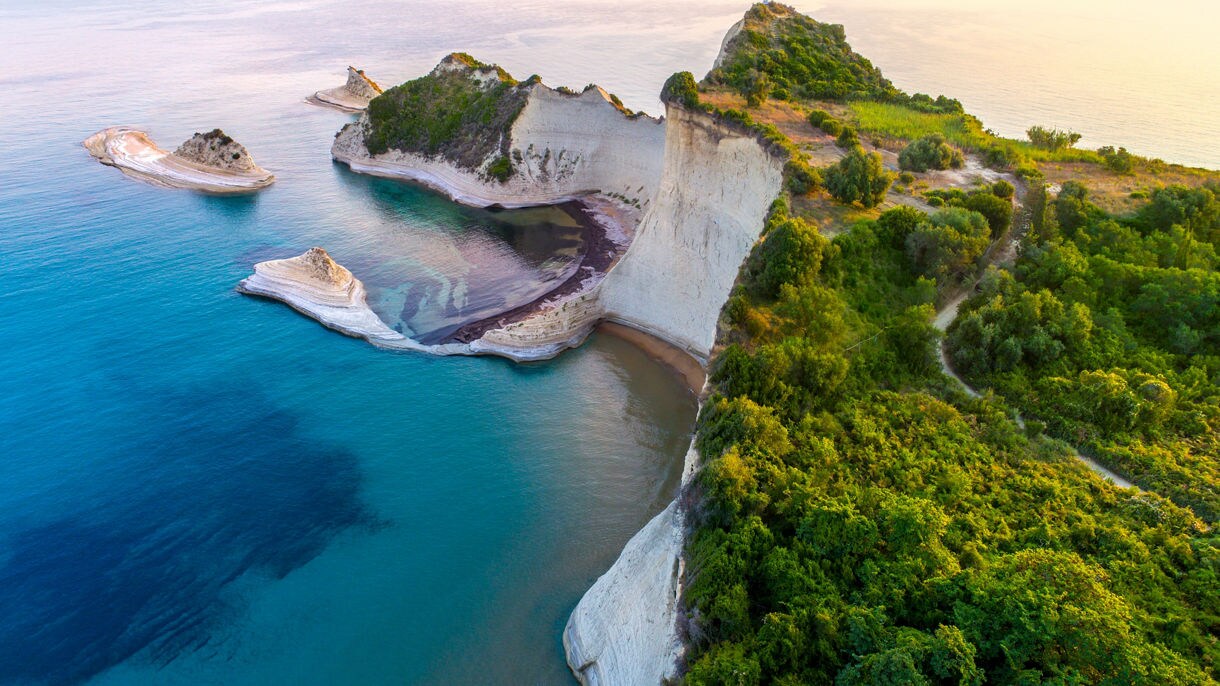 High above a tree-covered peninsula in Corfu