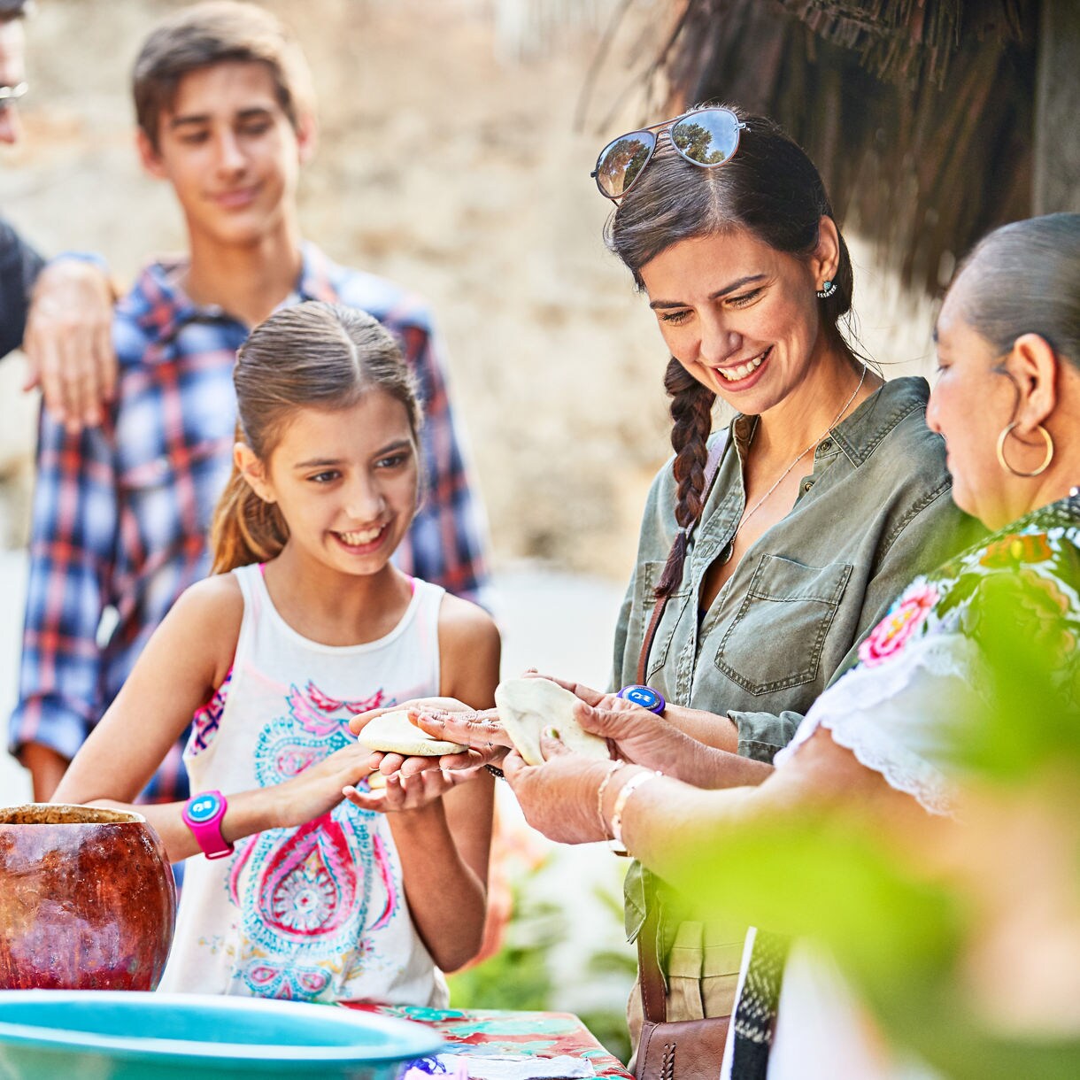 family learning how to make mexican pottery