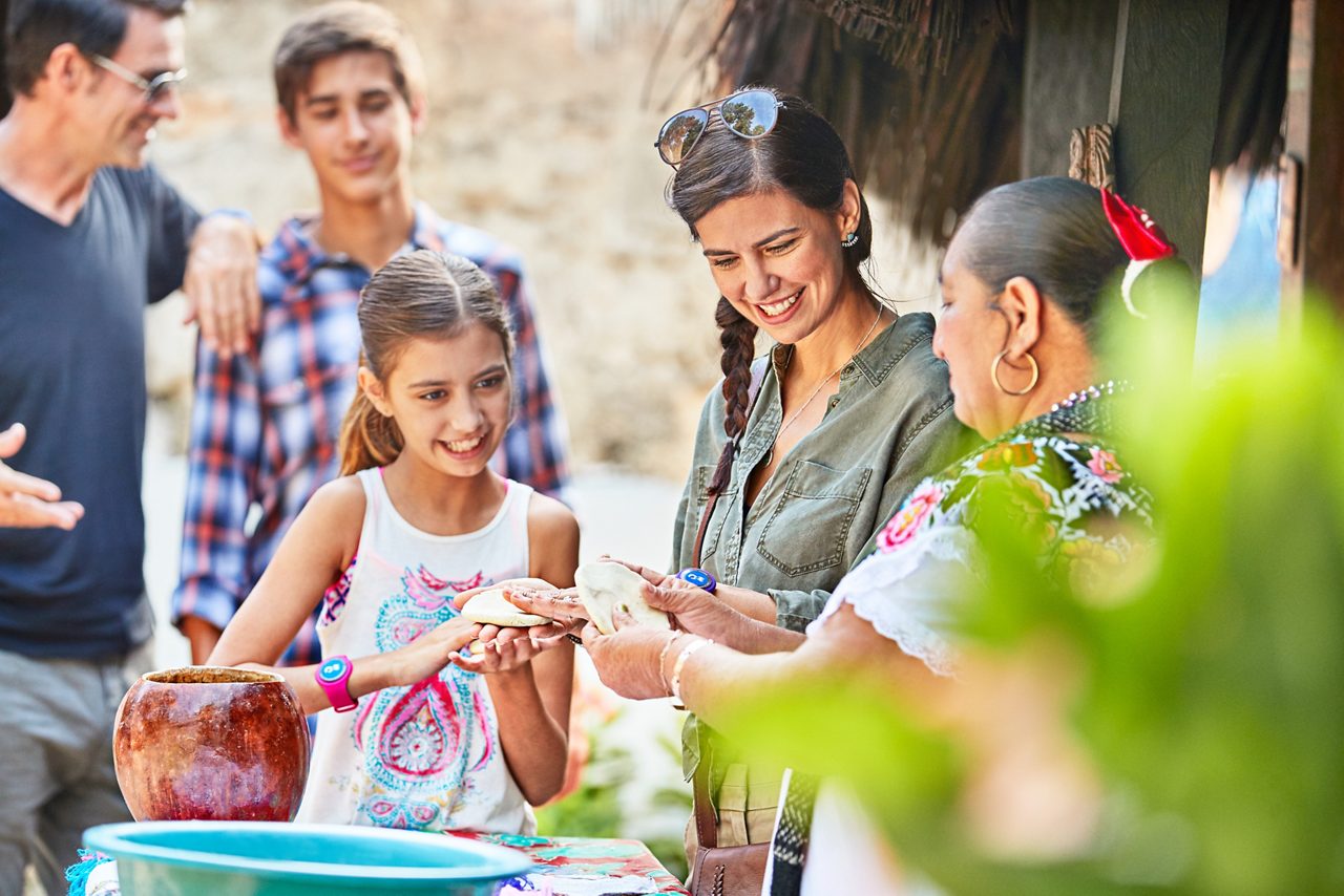 Family making Mexican flatbread