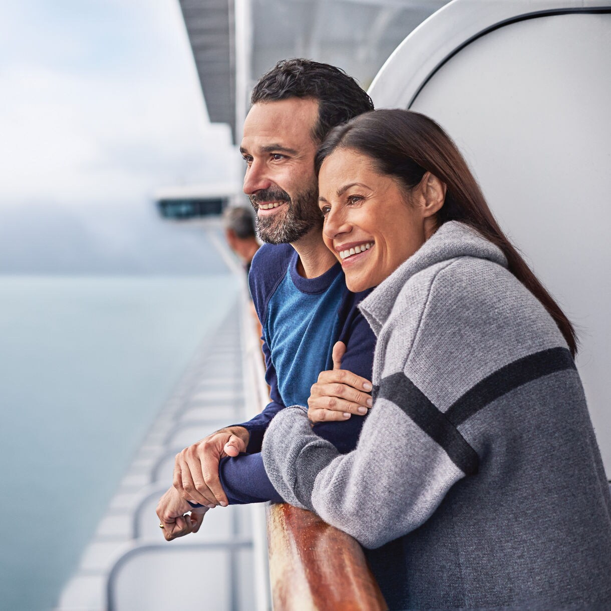 Couple at ship balcony in Alaska.