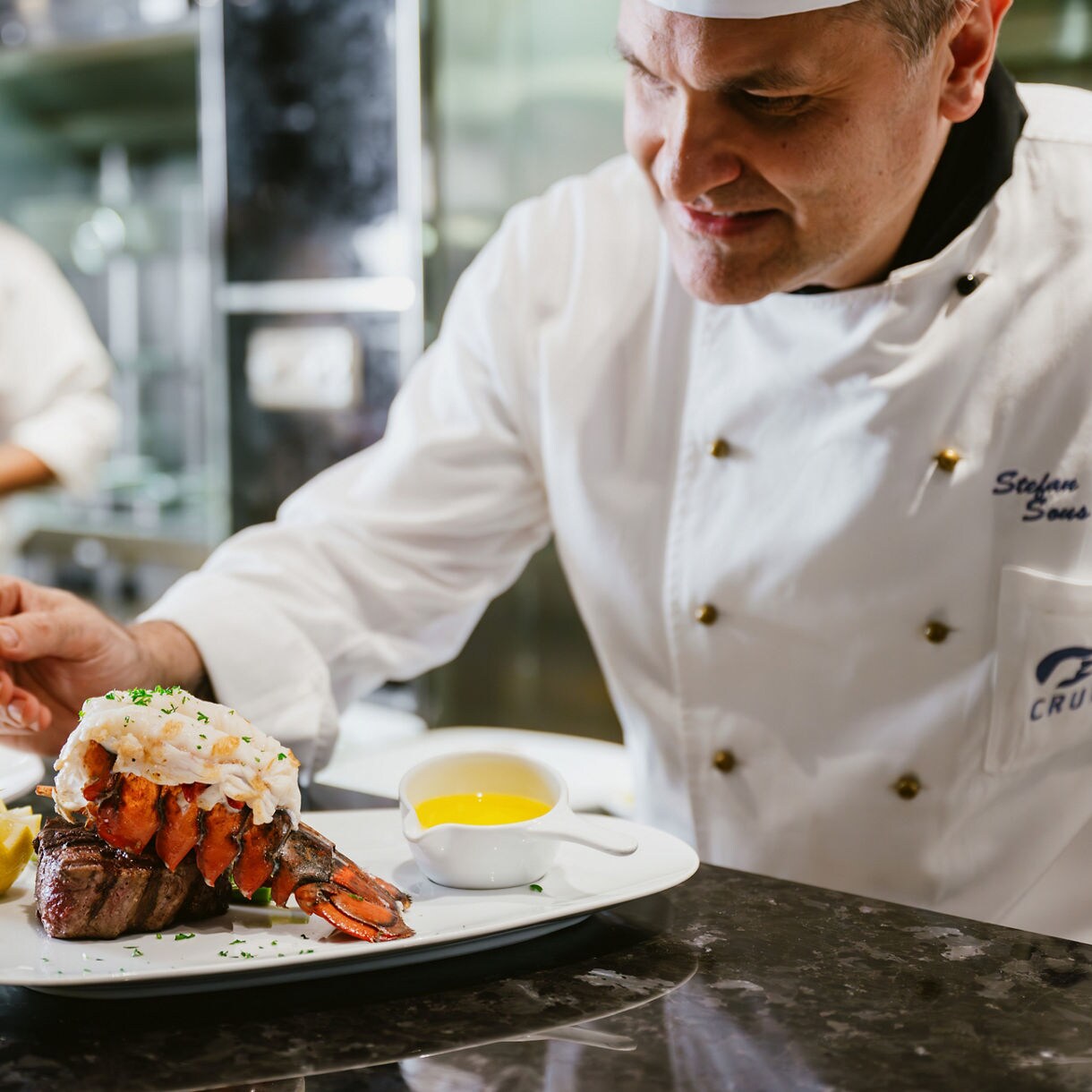 Chef preparing characteristic surf and turf.
