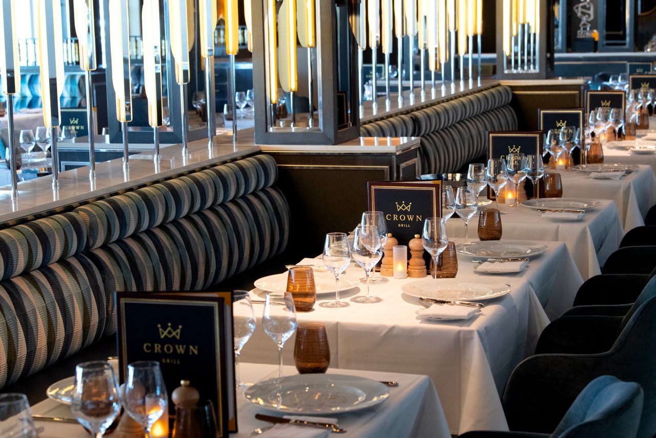 Crown Grill restaurant with tables and chairs arranged for a dinner party, ready to welcome guests.