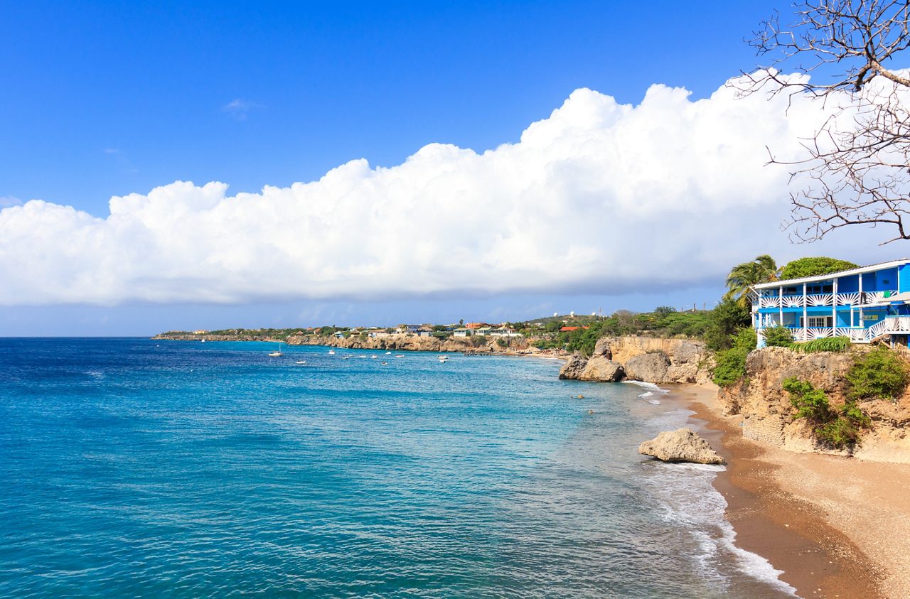 Seaside bluffs and anchored boats at Kenepa Beach.