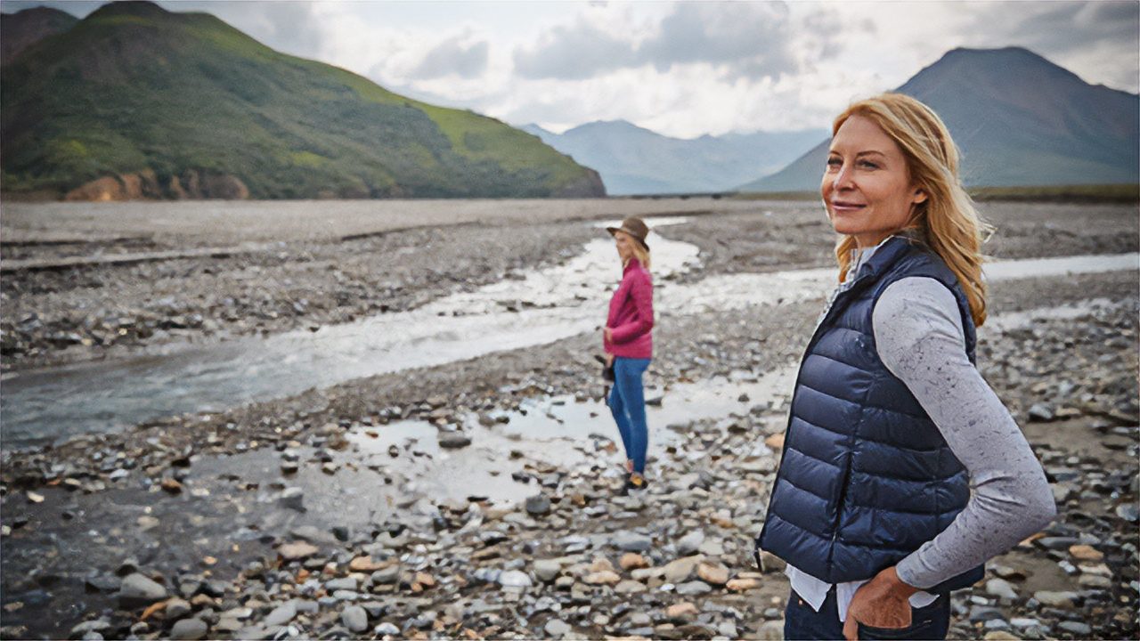 Two women enjoying the view of Denali park on an Alaska cruise.
