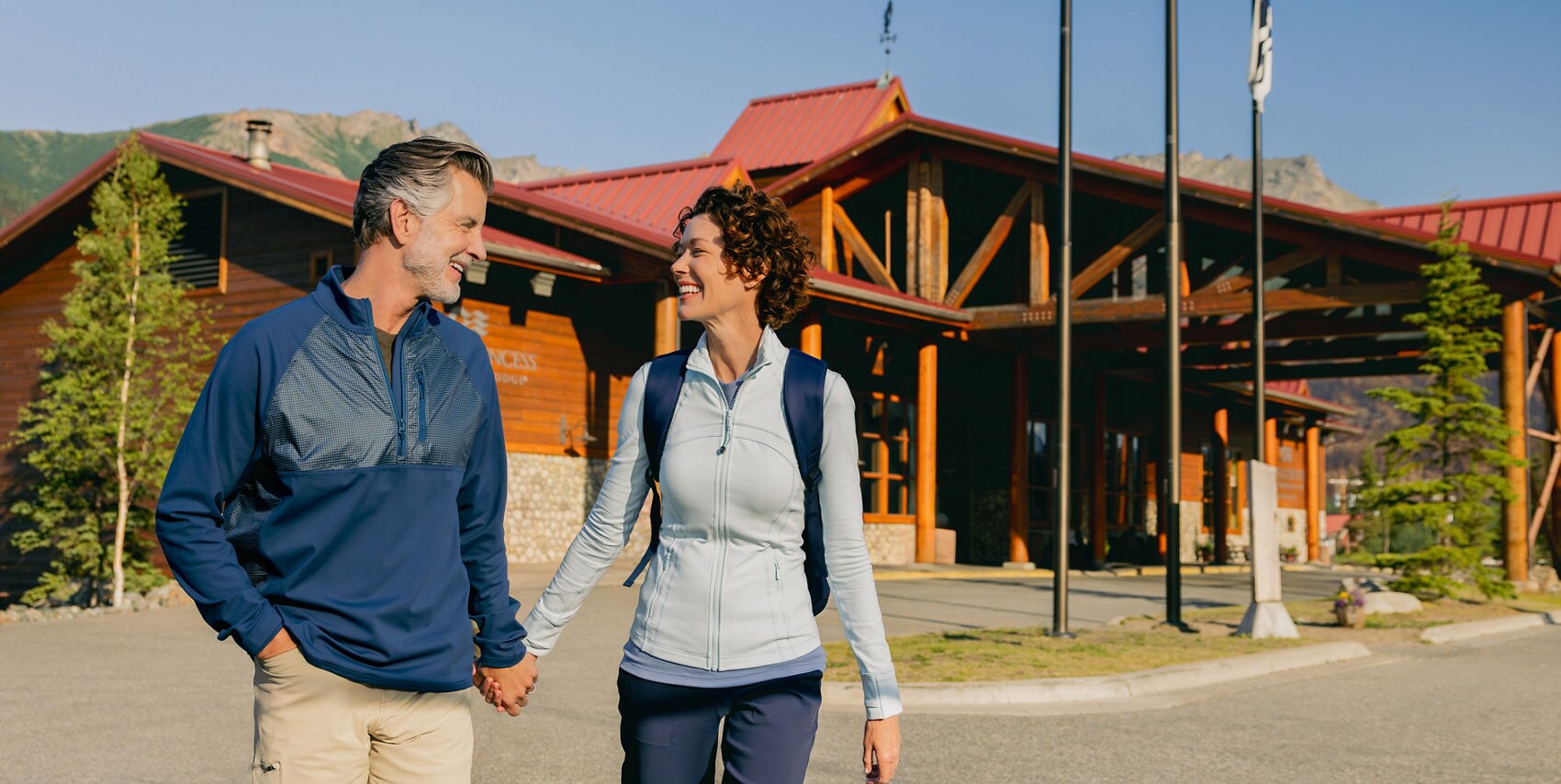 A couple walking on the grounds of the Denali Princess Wilderness Lodge.