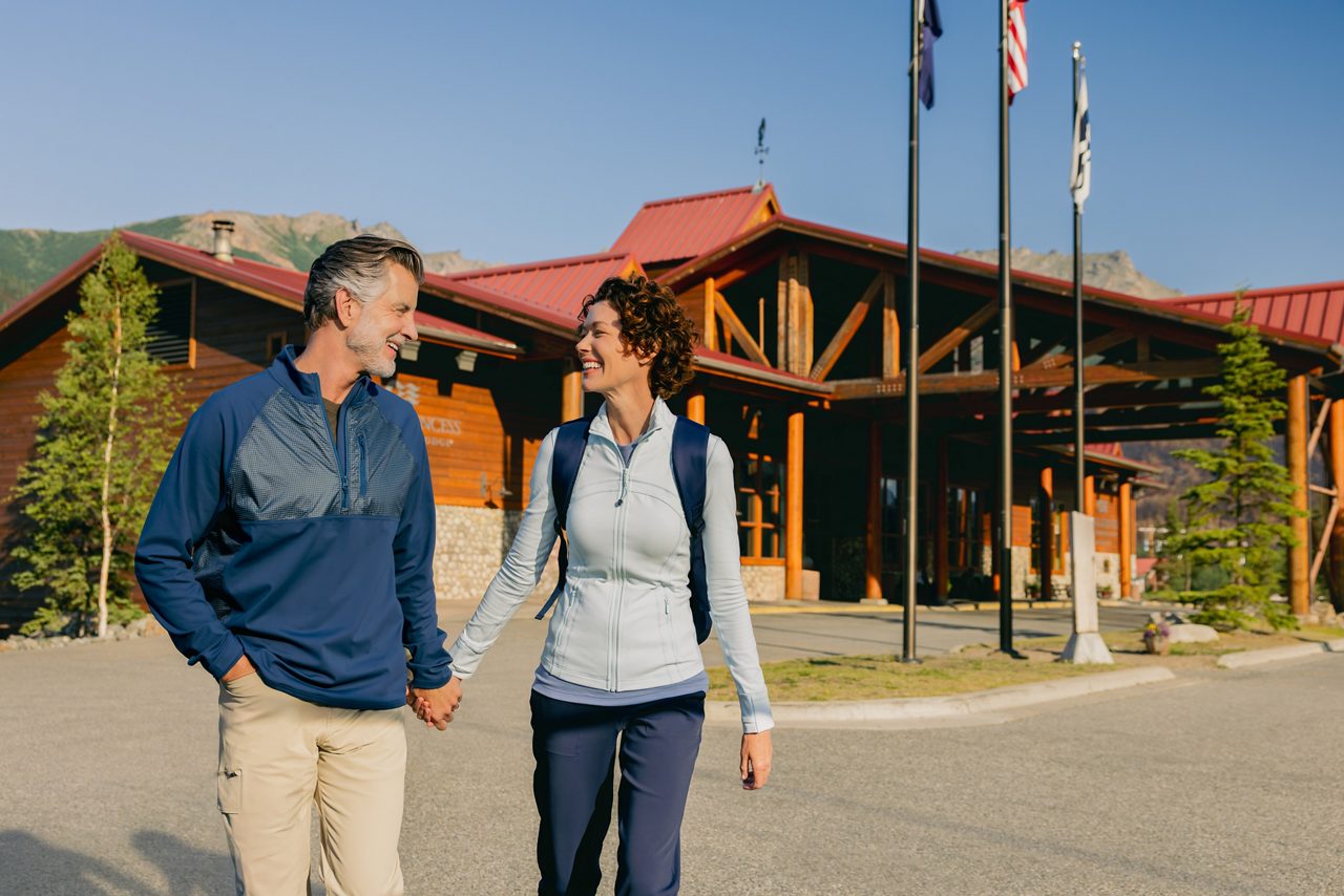 A couple walking on the grounds of the Denali Princess Wilderness Lodge.