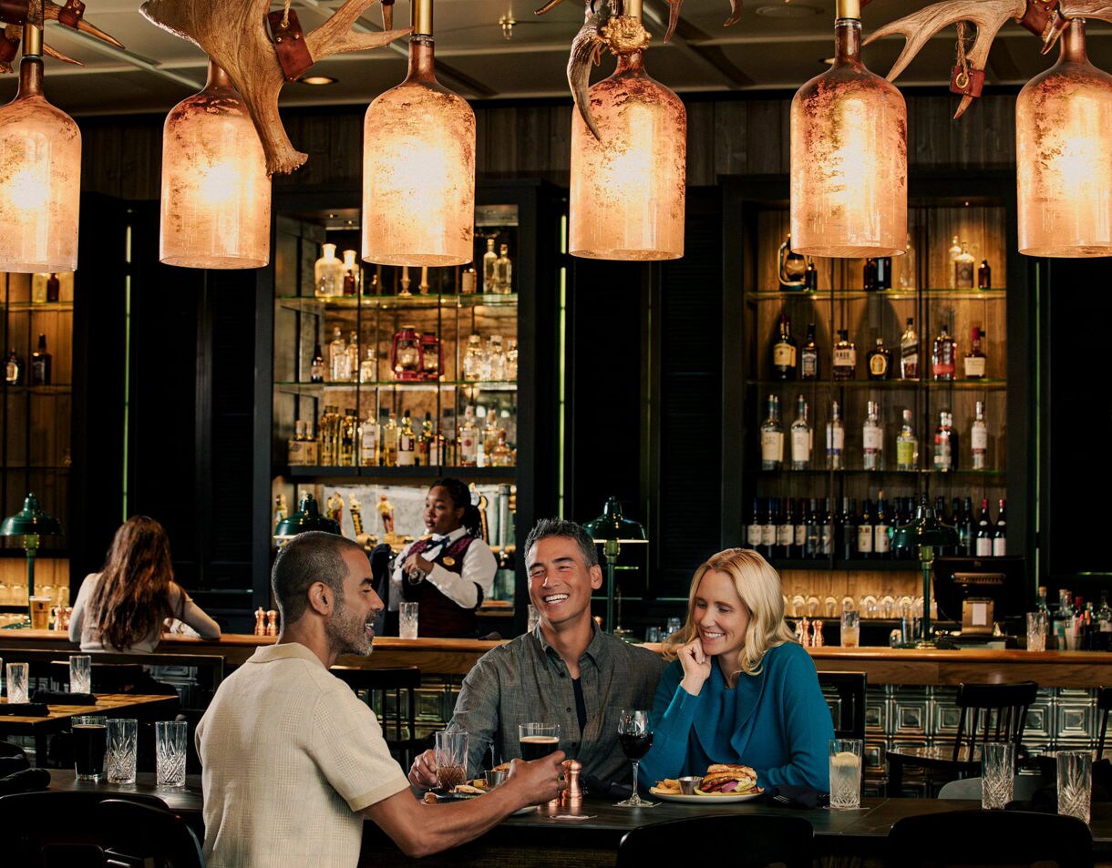 Seafood tartare with sesame breadstick and sauce dots on cucumber slice.