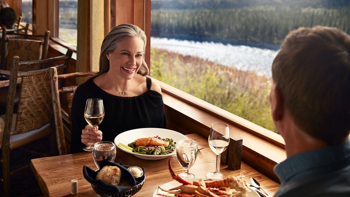 https://assets.princess.com/is/image/princesscruises/denali-wilderness-lodge-alaska-dining-room-couple-sharing-meal:16x9?ts=1699055384628